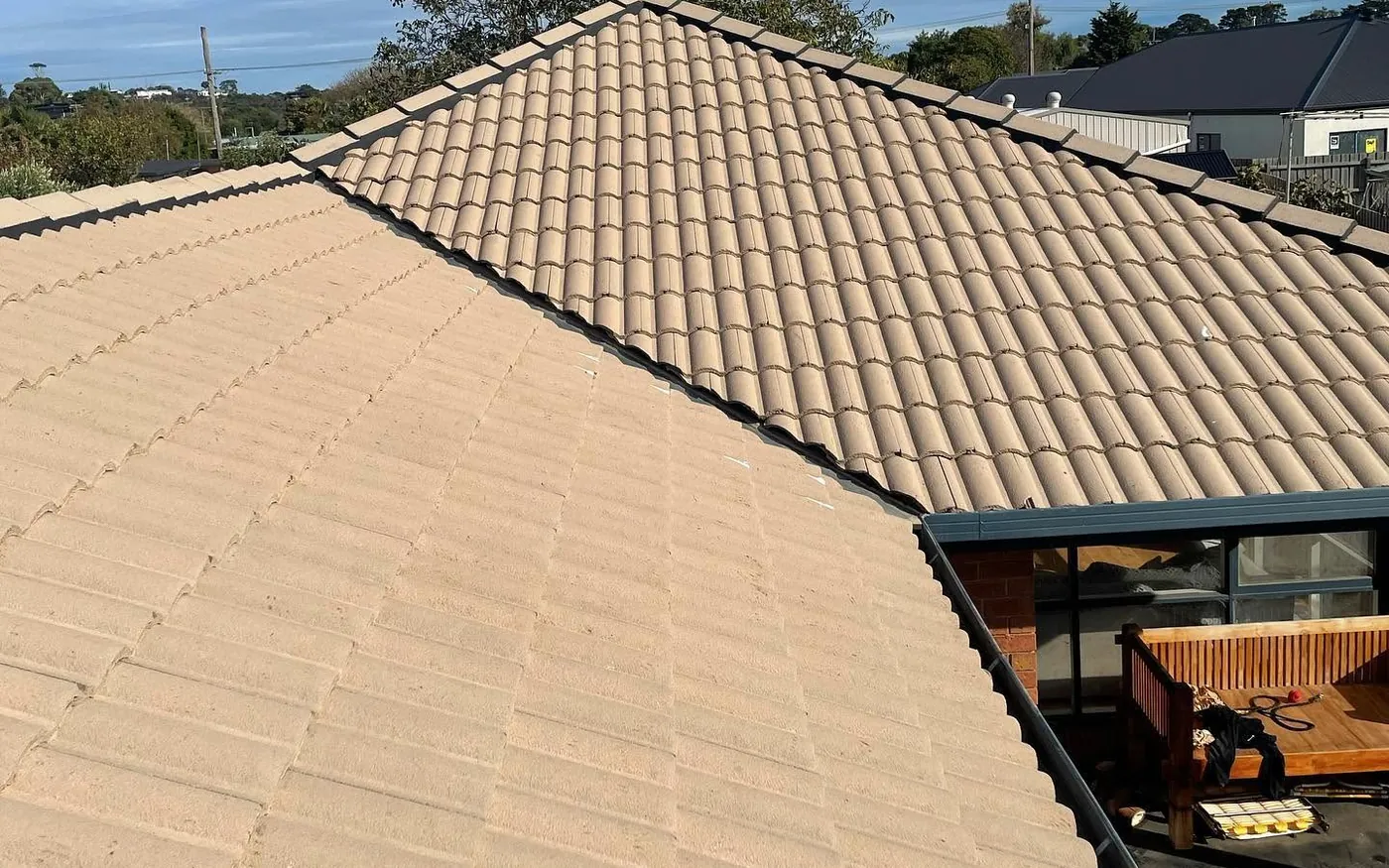 Bare, faded concrete hip roof before restoration